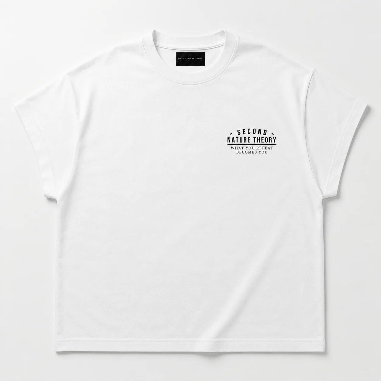 Kaos boxy tee warna putih, tampak depan, tulisan Second Nature Theory kecil di dada kiri